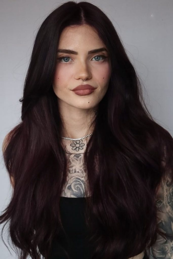 Deep plum noir sleek glossy hair.
