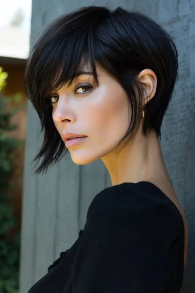 Edgy jet black pixie bob.