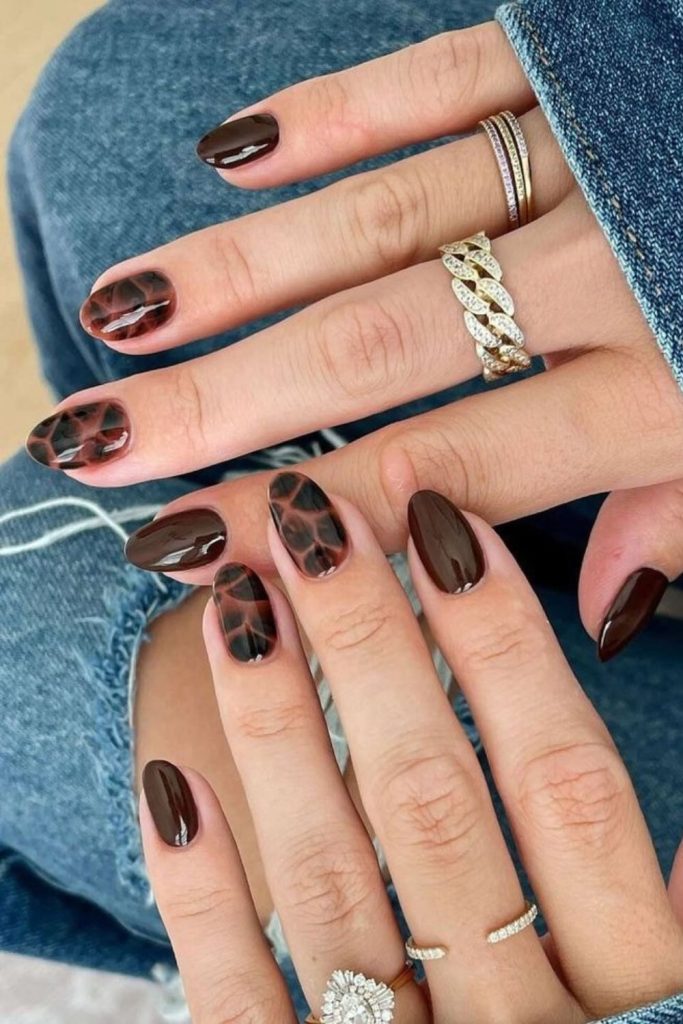 Espresso tortoiseshell nails with amber speckles.