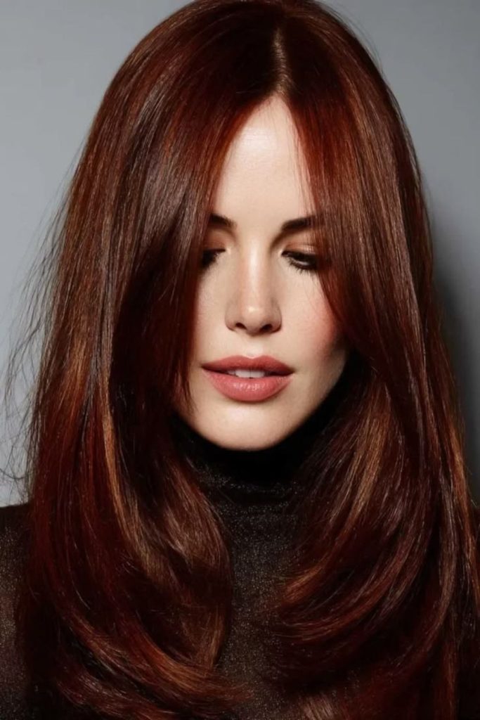 Fiery mahogany curls with vibrant highlights.