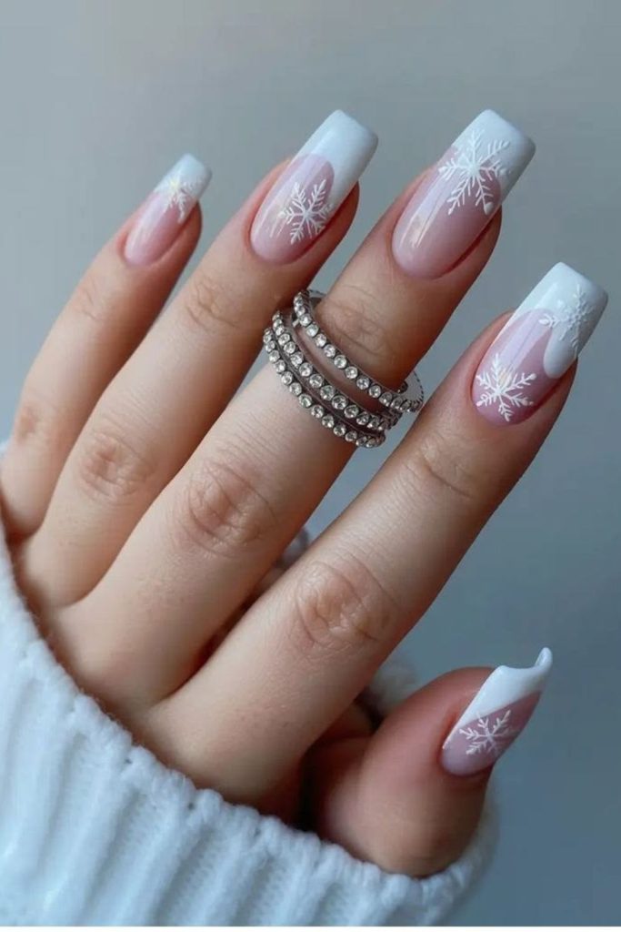 Frosted French tip snowflake nails.