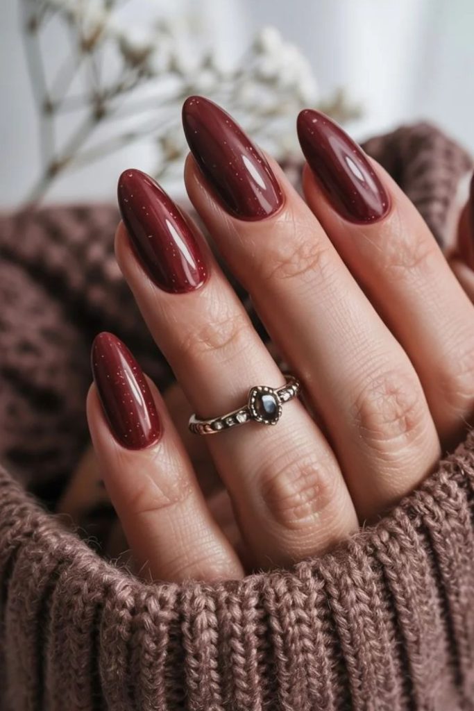 Glossy cranberry almond manicure design