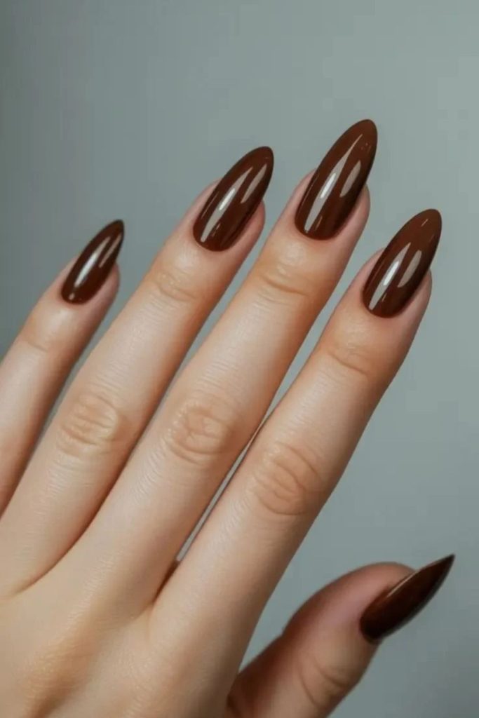Glossy mocha almond nails with rich color.