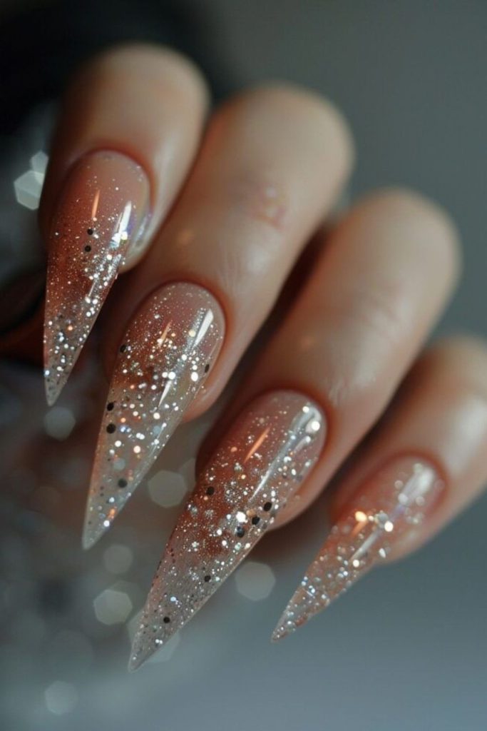 Champagne gold shimmer stiletto nails.