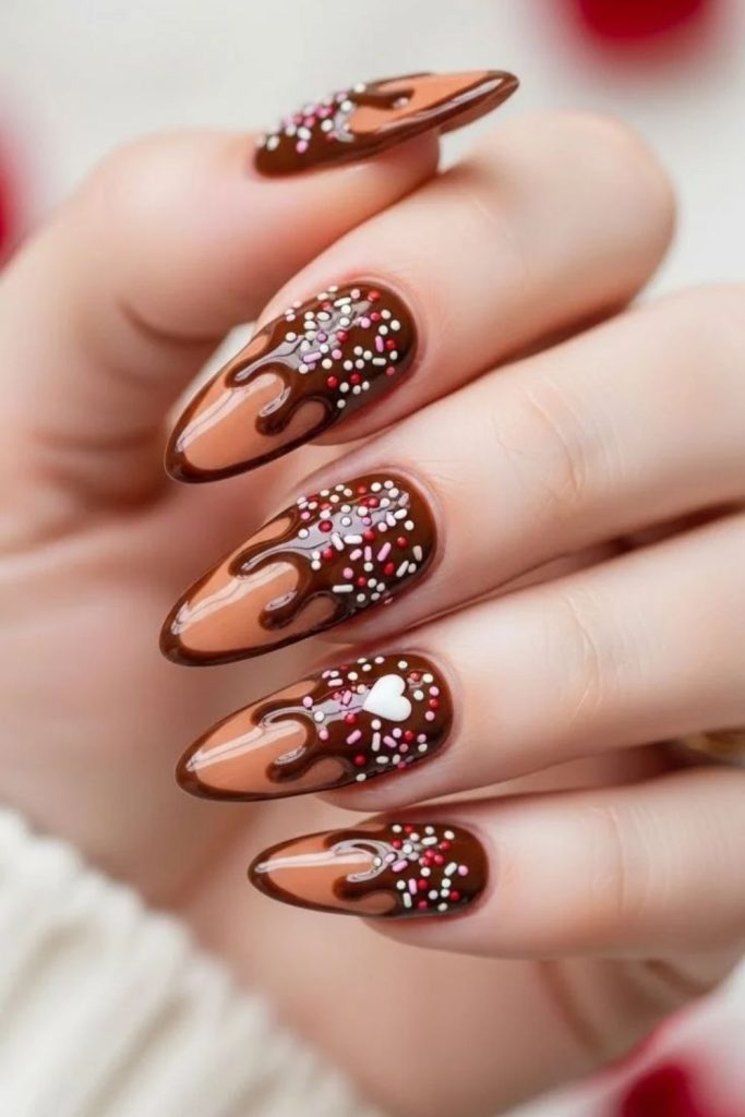Hot cocoa nails with colorful sprinkles.