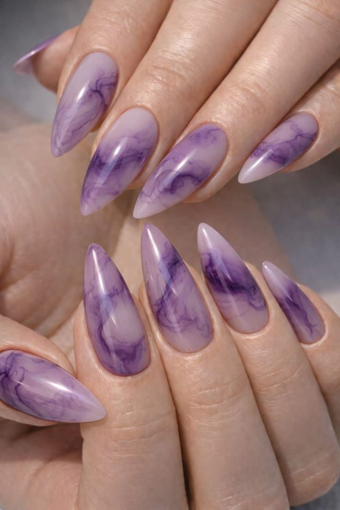 Dreamy lavender marble stiletto nails.