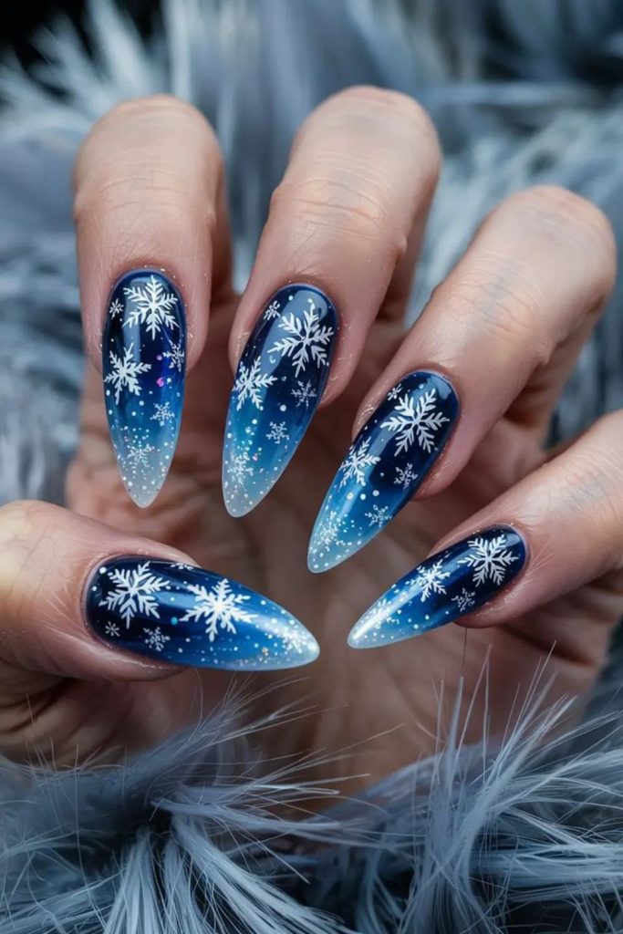Midnight navy winter snowflake nails.