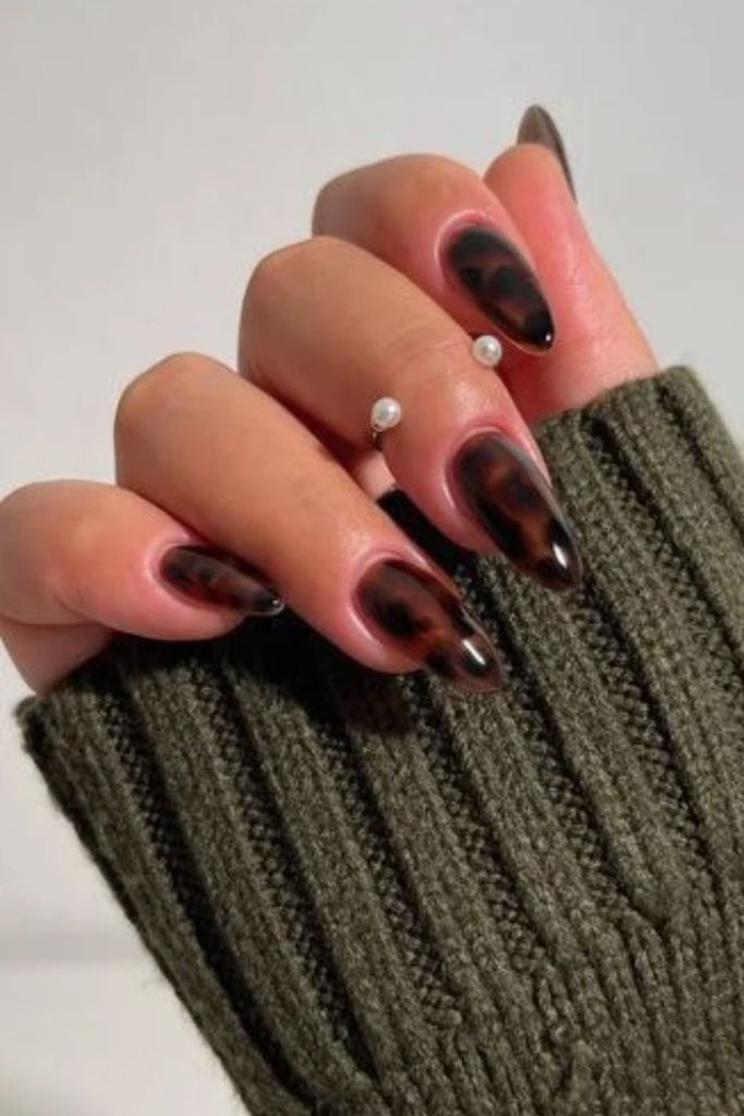 Dark brown midnight tortoise nail design.