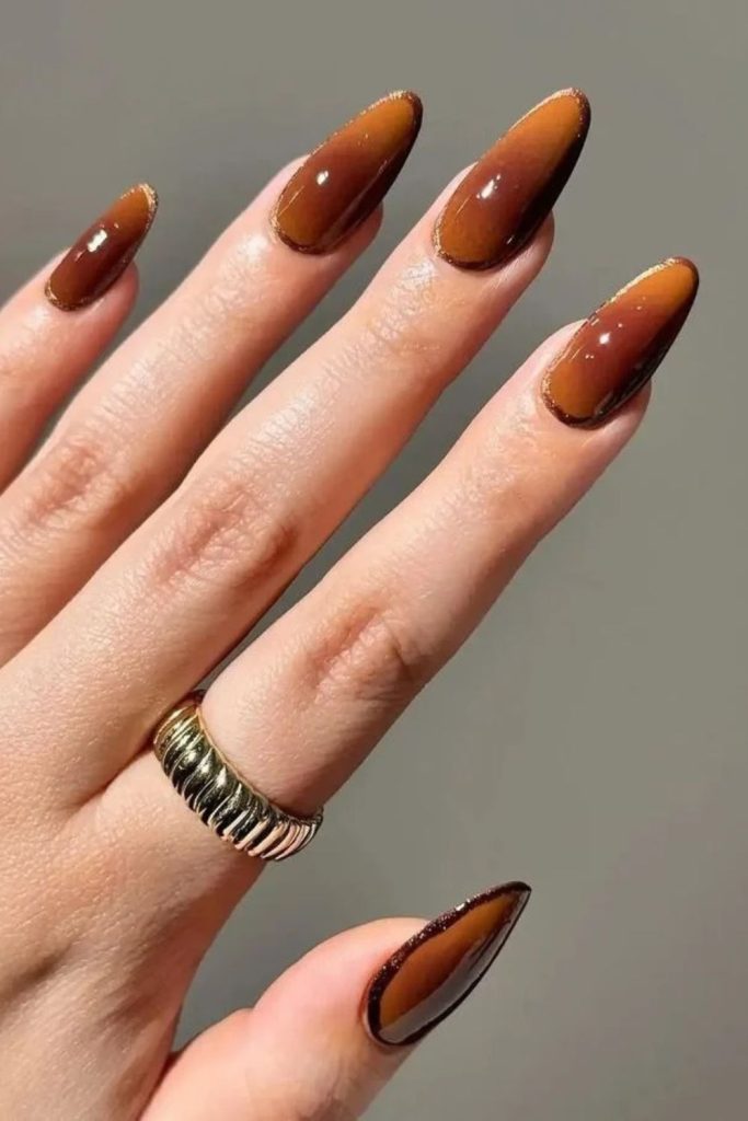 Mocha aura nails with dreamy glow.