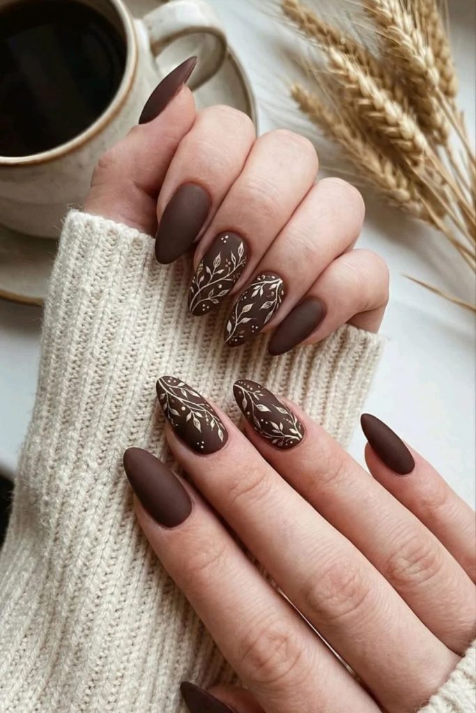 Mocha nails with delicate botanical lines.