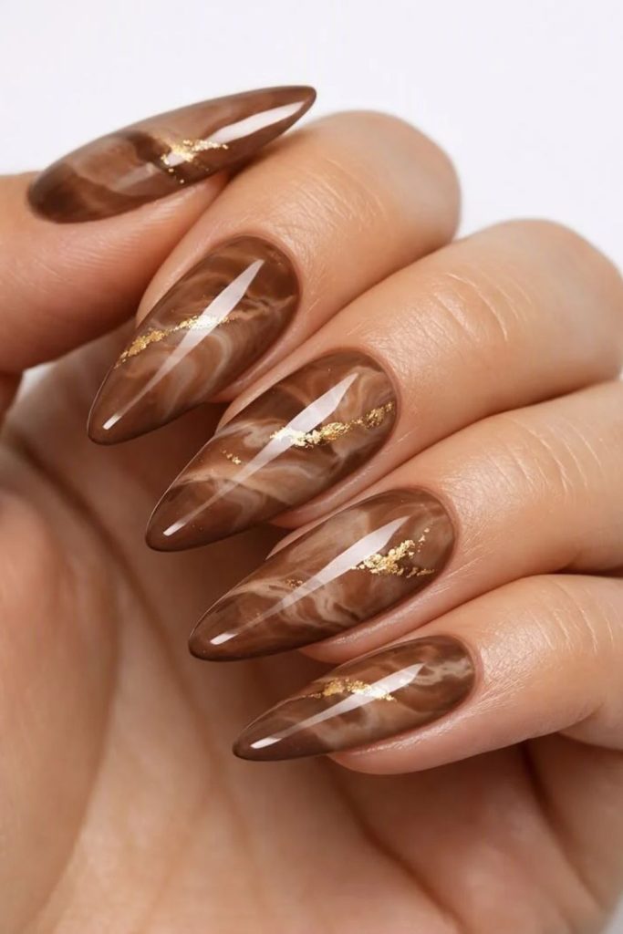 Cocoa mocha nails with artistic swirls.