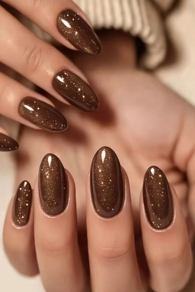 Mocha glitter nails with subtle sparkle.