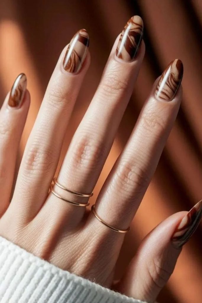 Marble mocha nails with creamy swirls.