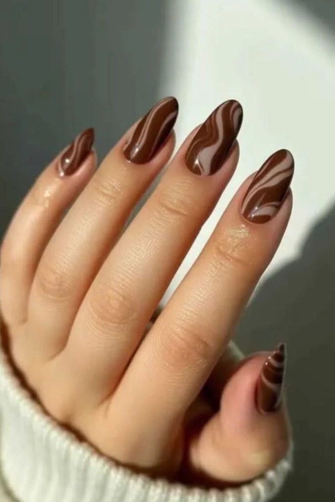 Mocha swirl nails with creamy accents.