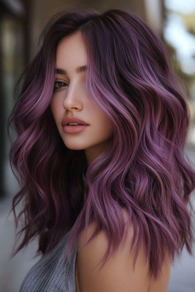 Plum ombre flowing violet gradient hair.