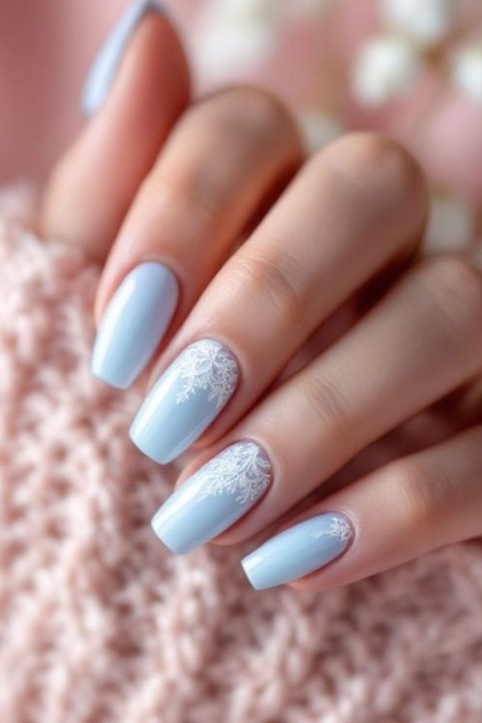 Powder blue delicate snowflake nails.