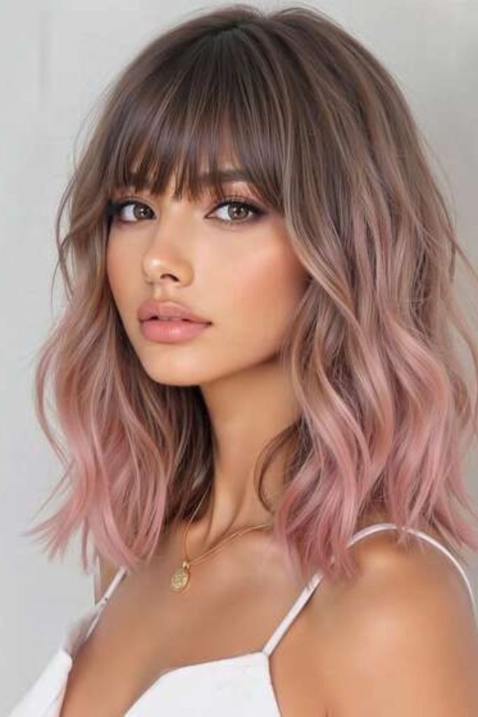 Rose gold rooted blonde hairstyle.