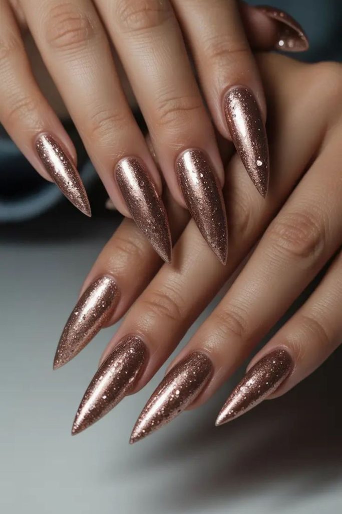 Rose gold glitter stiletto nails.