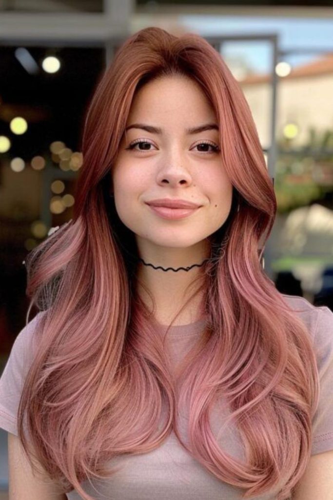 Rose gold velvet hair with curls.