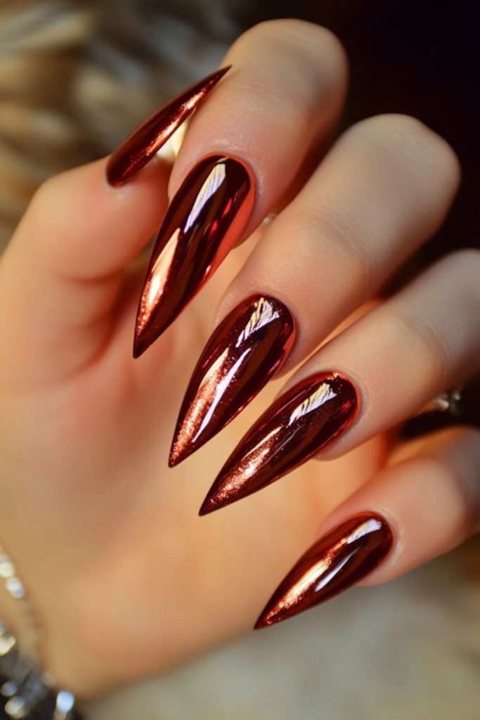 Scarlet red chrome stiletto nails.