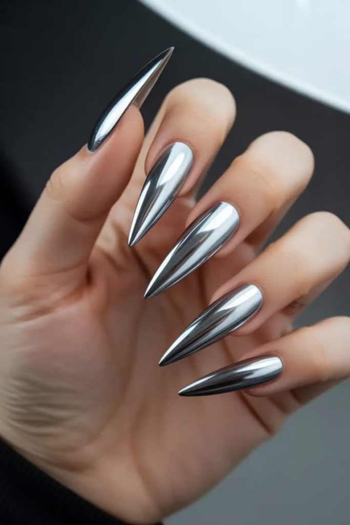 Reflective silver mirror stiletto nails.
