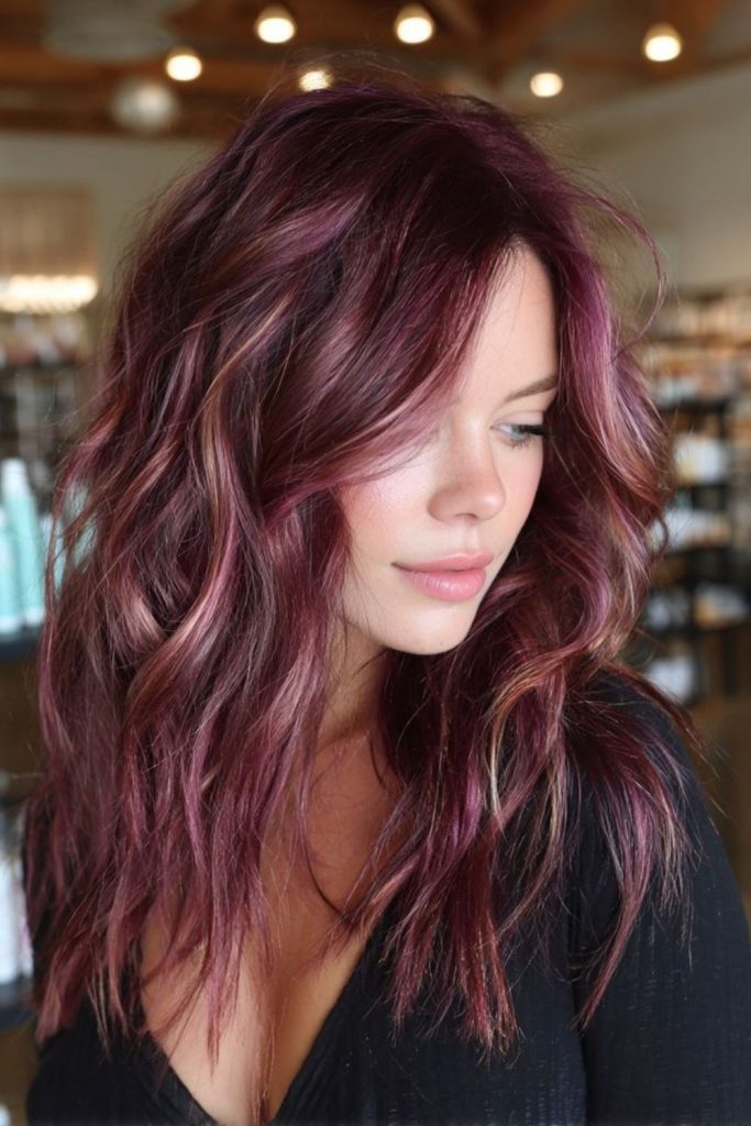 Soft plum balayage on brunette hair.