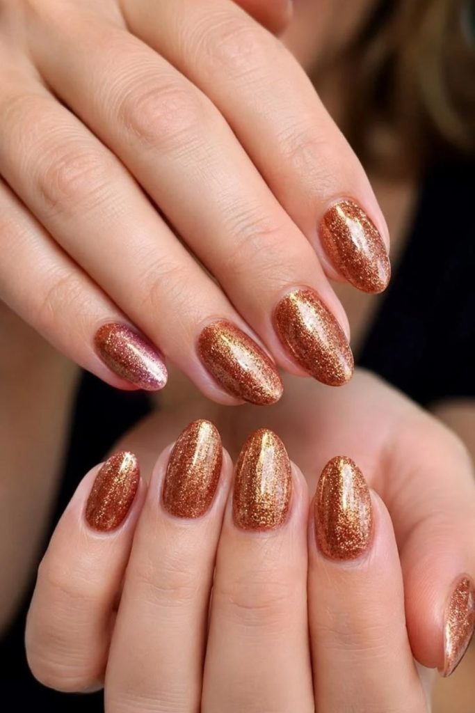 Sunset gold sparkle nail design