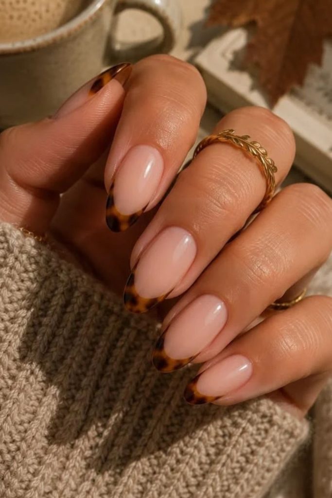 Tortoiseshell French tips on almond nails.