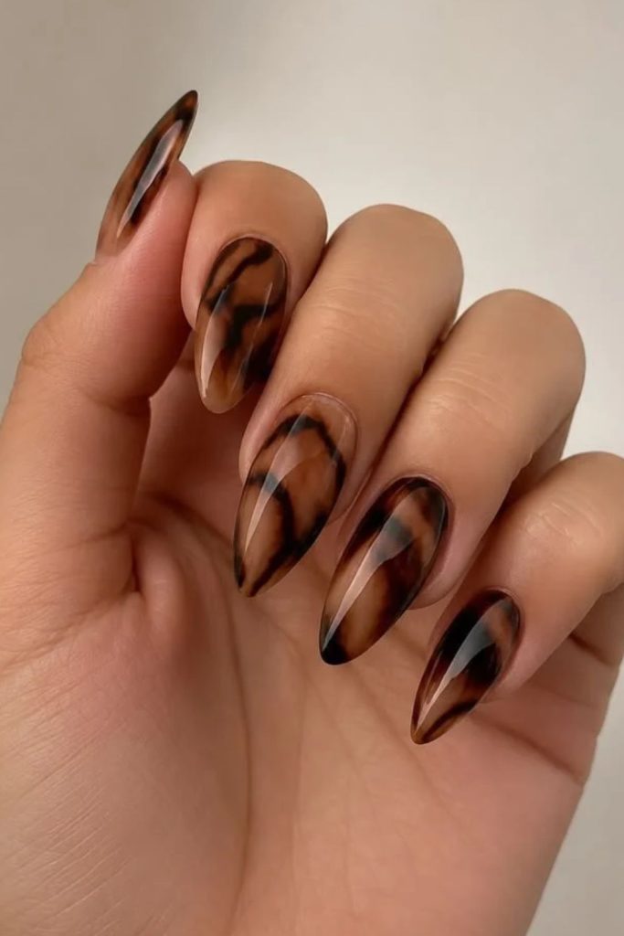 Swirled tortoiseshell French tip nails.