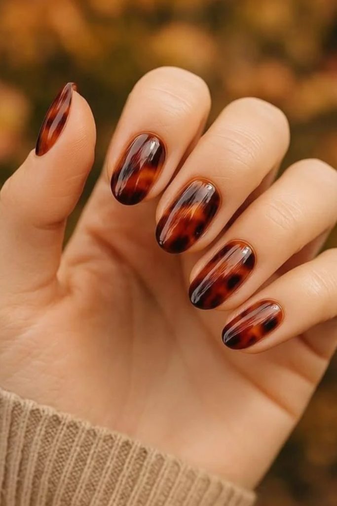 Amber aura tortoiseshell glossy nails.