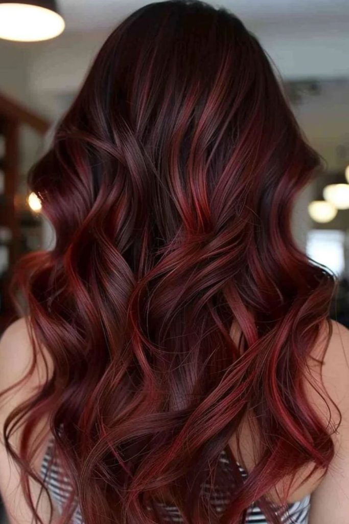 Velvet red balayage with brunette dimension.