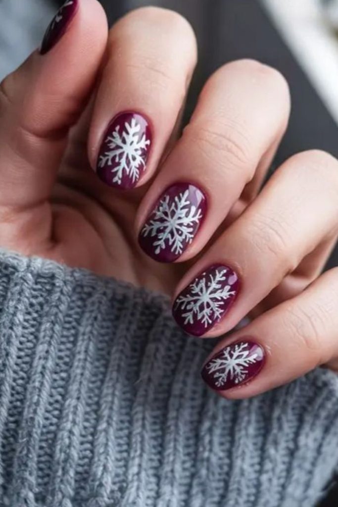 Cranberry winterberry snowflake nail design.