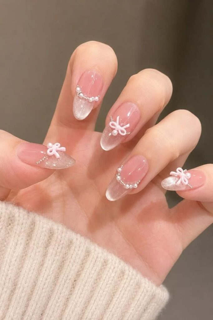 Three-dimensional coquette nails with sculpted ribbon embellishments.