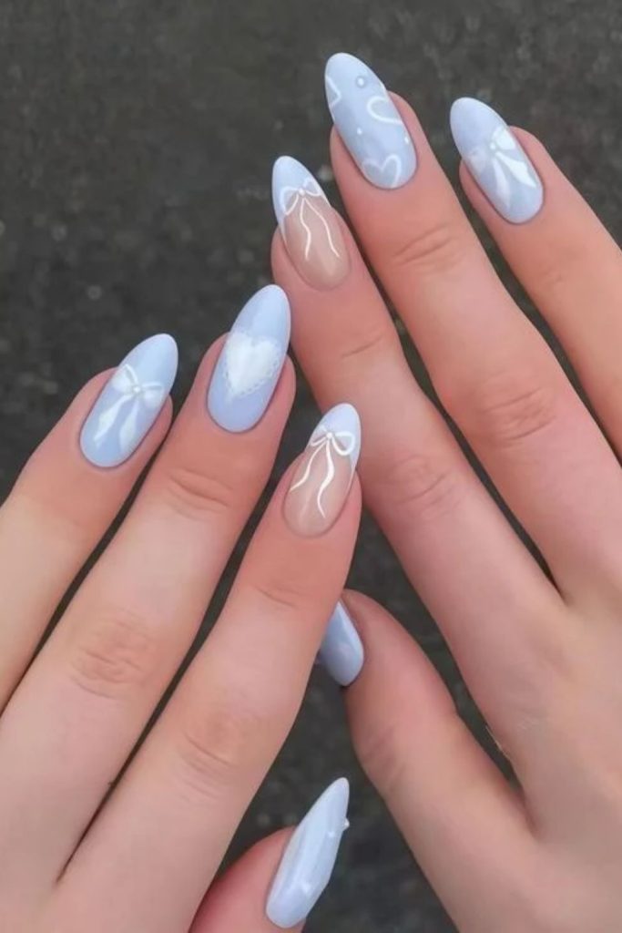 Baby blue coquette nails with white bows.