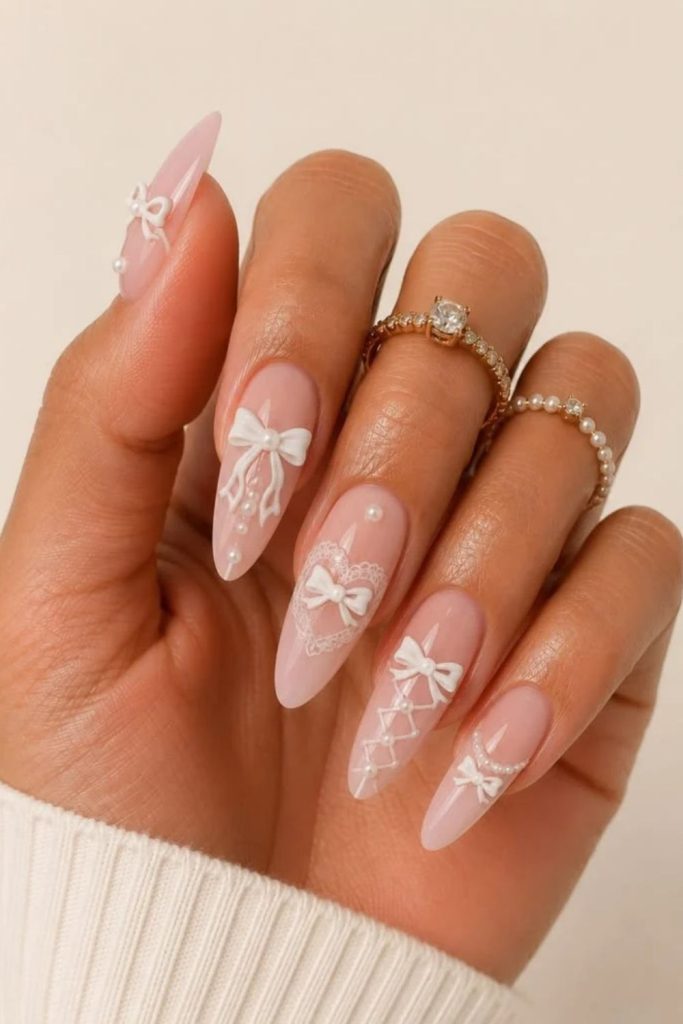 Balletcore coquette nails with soft pink ribbons.