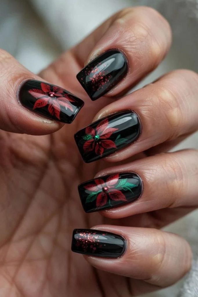 Black nails featuring bold red poinsettia flowers.
