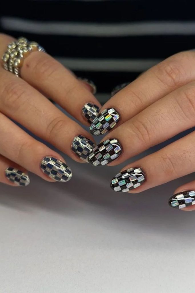 Black and silver disco nails with metallic sparkle.