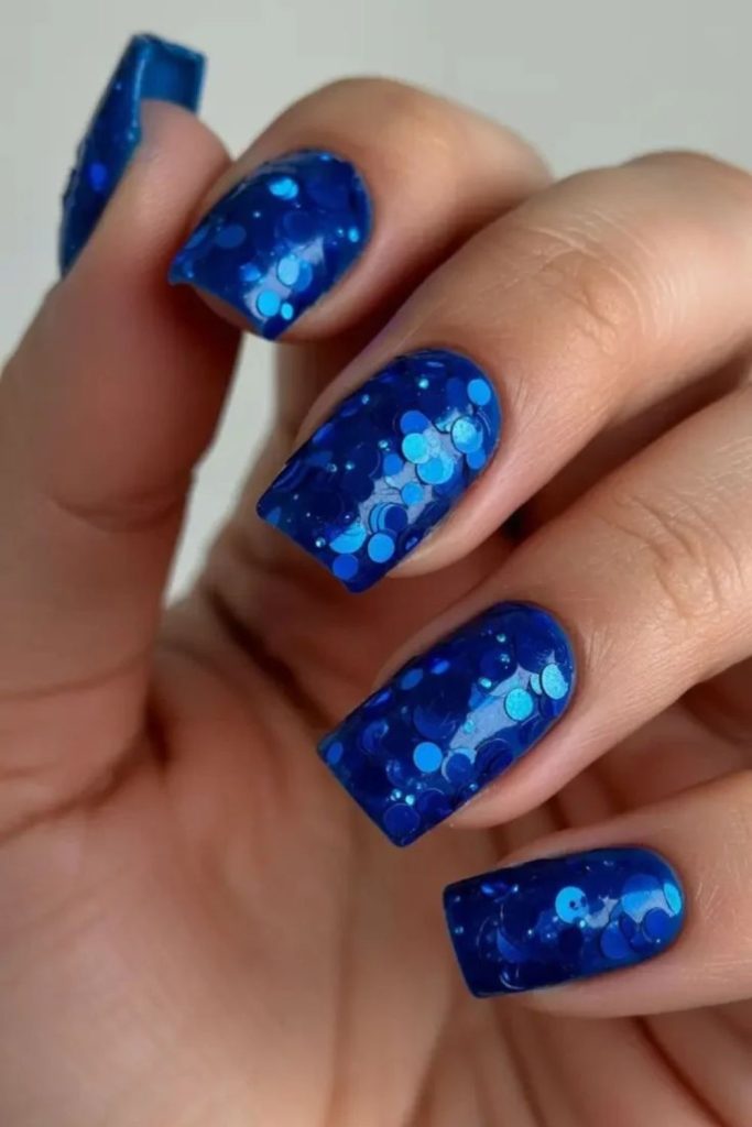 Blue disco ball nails with icy silver accents.