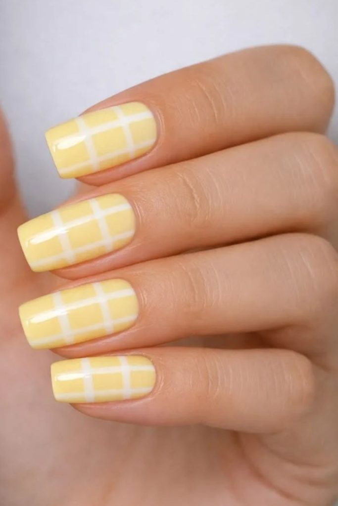 Butter yellow checkerboard nail art.