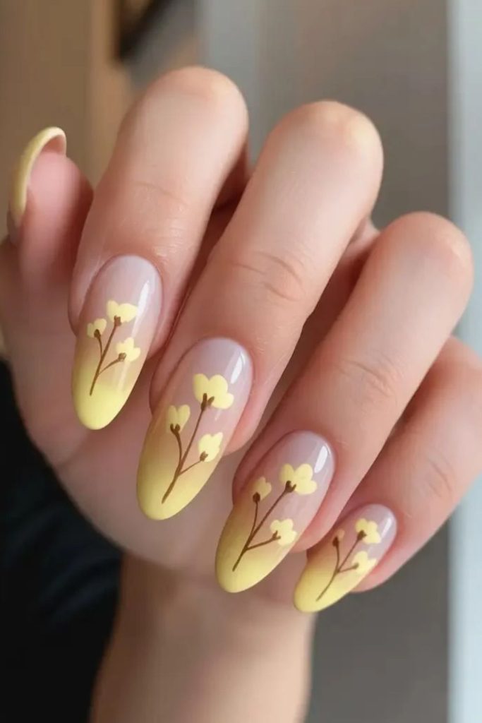 Butter yellow floral French tip nails.