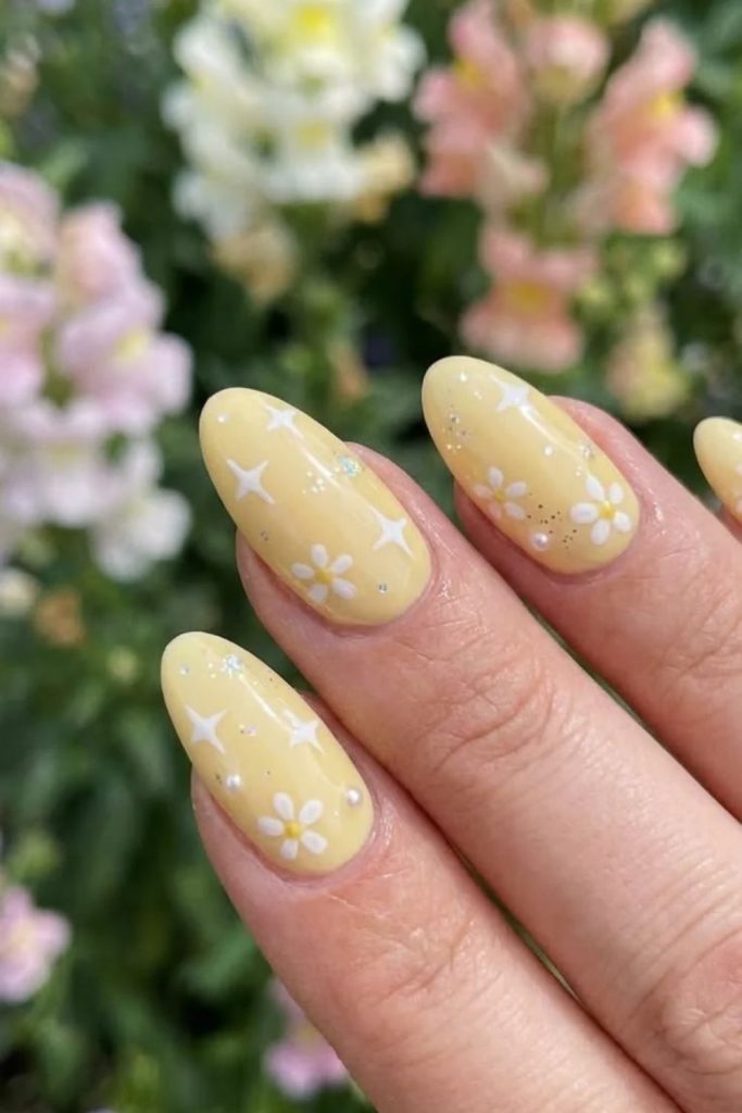 Butter yellow starry nail art.