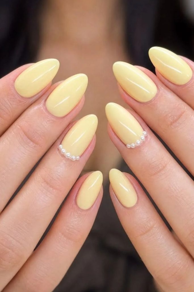 Butter yellow pearl elegant manicure.