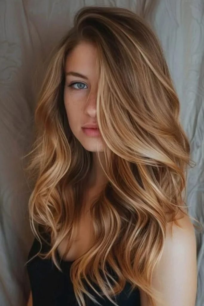 Butterscotch blonde balayage with flowing waves.