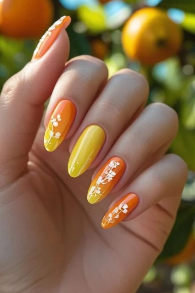 Candy corn nails with delicate floral accents.