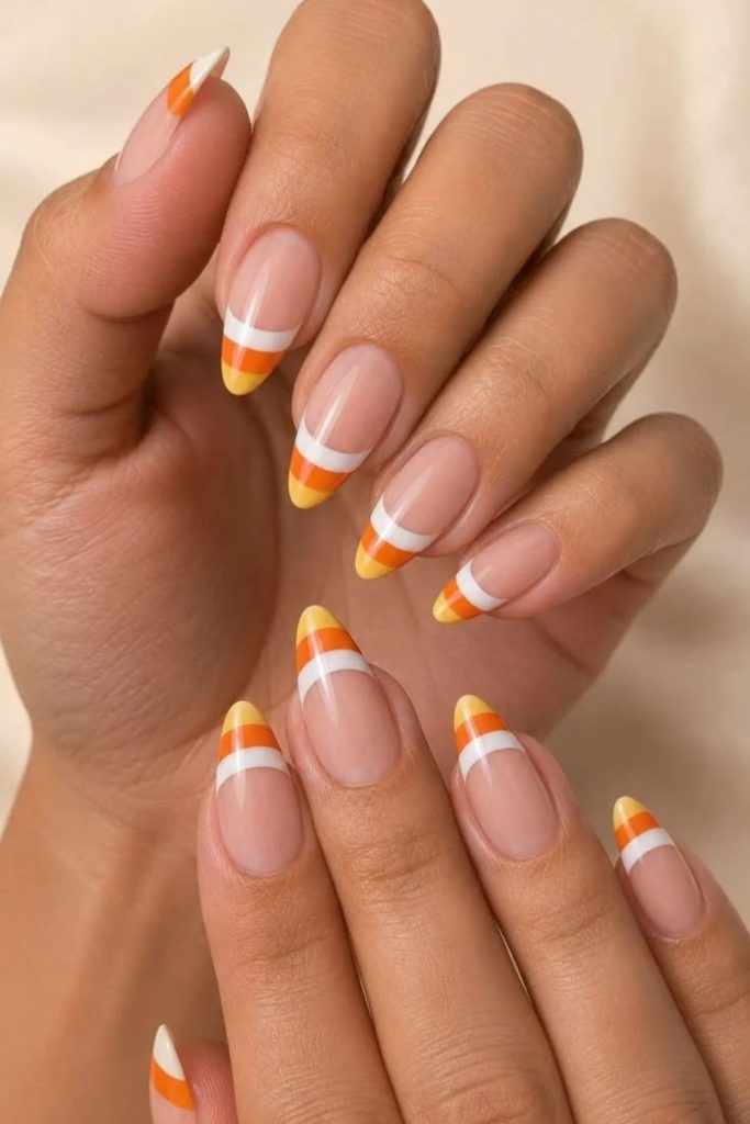 Candy corn French tips on nude nails.
