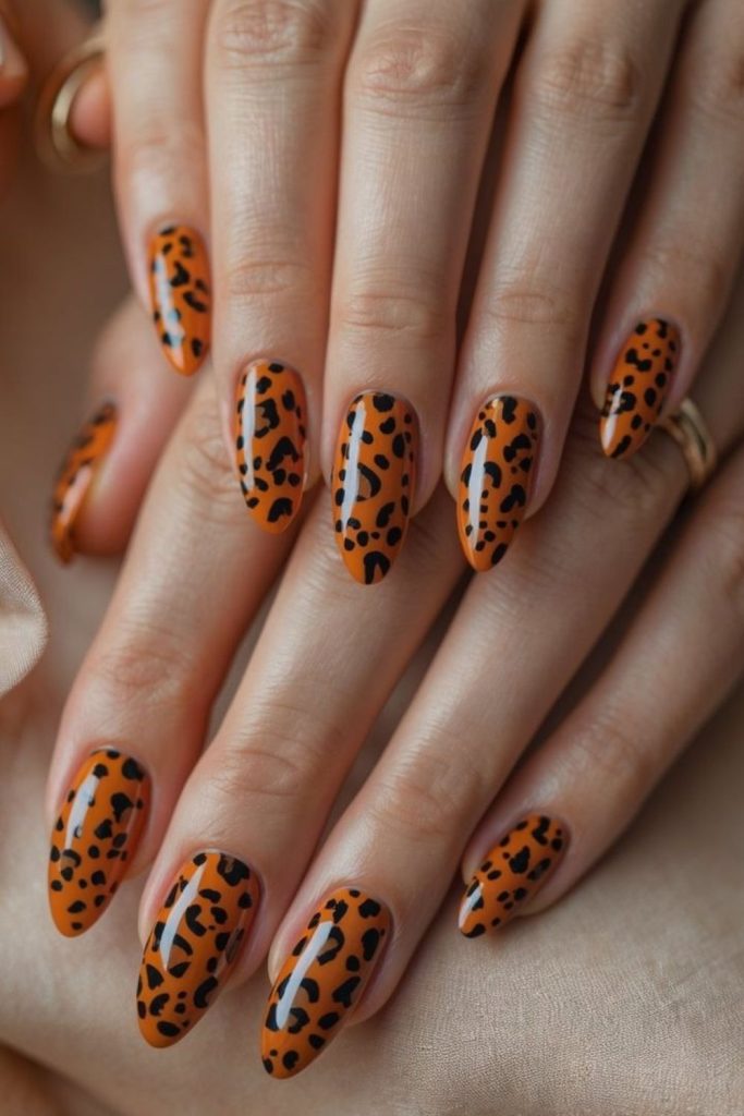 Candy corn nails with bold leopard spots.