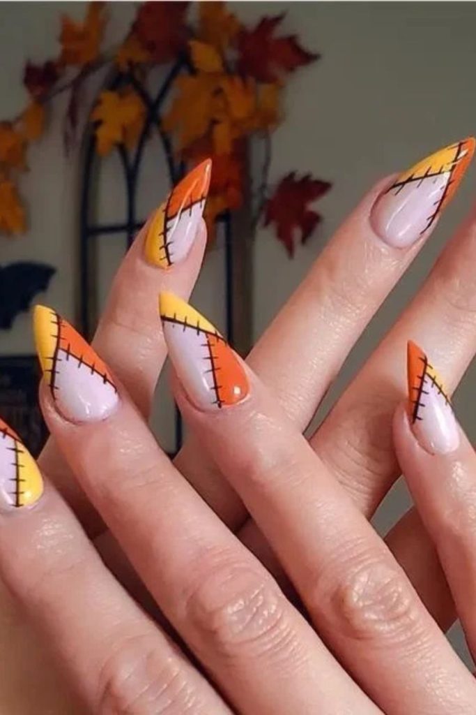 Minimalist candy corn nails with negative space.