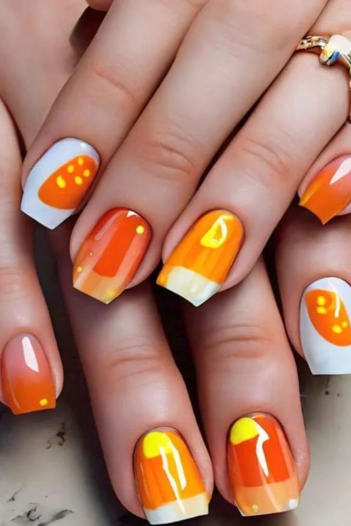 Colorful candy corn Skittle Halloween nail manicure.