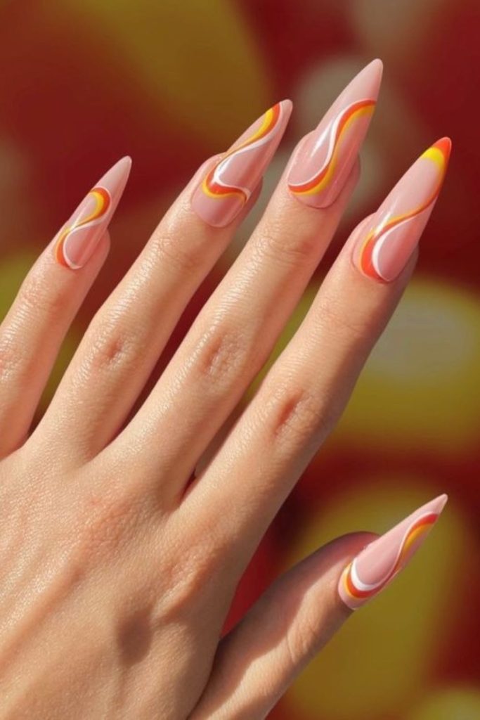 Swirled yellow orange and white candy corn nails.