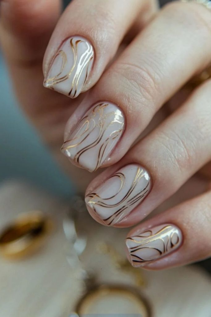 Champagne Marble Swirl Nails with Golden Veins.